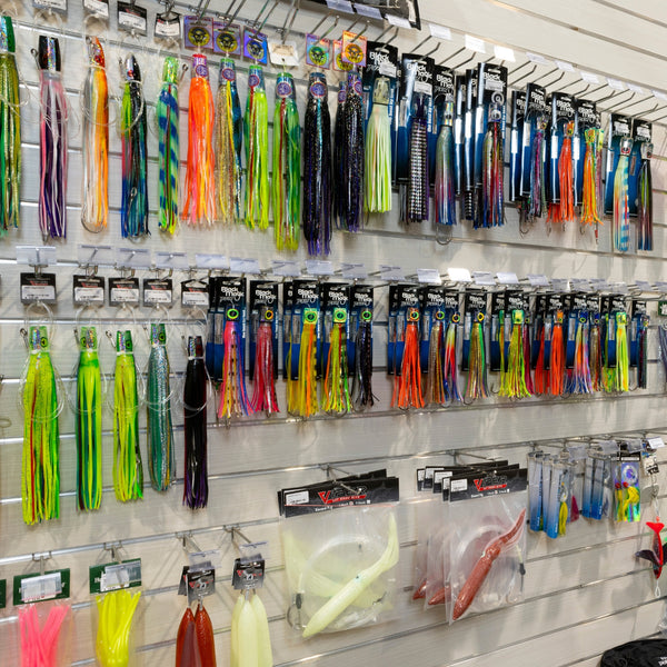 Display of various fishing lures mounted on a Plankwall slatwall Retail display wall panel.