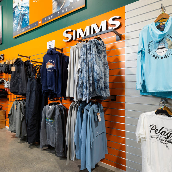 Clothing display mounted on Plankwall slatwall wall panels in orange and blonde wood