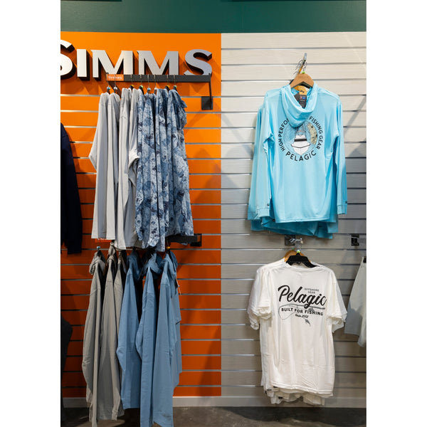 Clothing display mounted on Plankwall slatwall wall panels in both orange and blonde wood finish