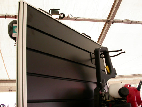 Close-up of pvc inserts in all black slatwall panel