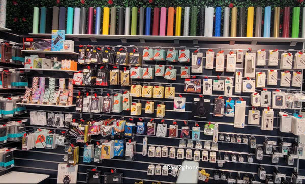 Display of trading cards in a store mounted on Plankwall 100mm Black slatwall panels with shelves and a counter.