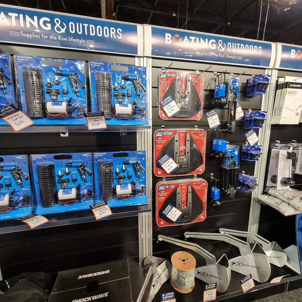 close up of Plankwall black free-standing slatwall display walls with black inserts shown with merchandise at a boat exhibition show. With plinth base,  2200m High