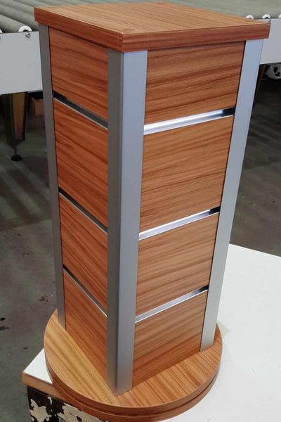 Plankwall Counter Top Retail Display stand with slatwall grooves in a wood finish in a factory setting