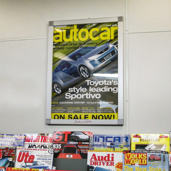 A3 Poster frame displaying a cover of Autocar above a rack of magazines