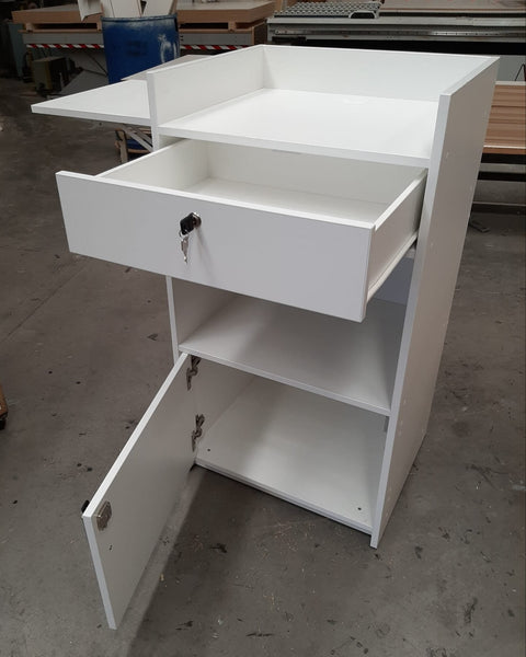 Small Plankwall Retail Counter Unit in white with lockable drawers open in a factory section
