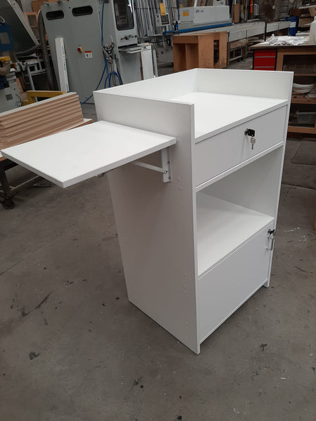 Plankwall small retail counter in white with lockable drawers and side latch shelf in a factory setting