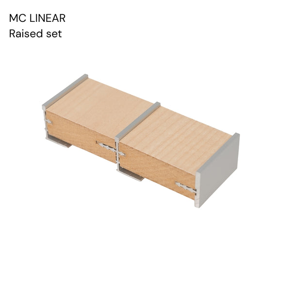 close up sample of MDF panels joined with Stickman Linear aluminium wall fix butt joins MCLNWFJOIN capped with MCLNCAP in raised set on a white background 