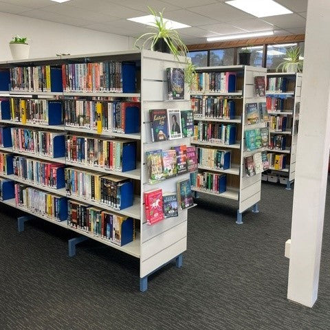 Whangamata library bay end slatwall displays with featured books in white