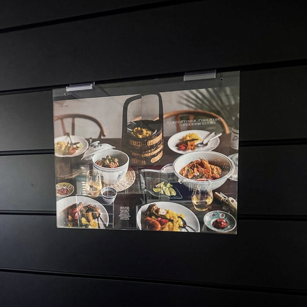 double page food editorial for a restaurant with images of food on a black display slatwall 