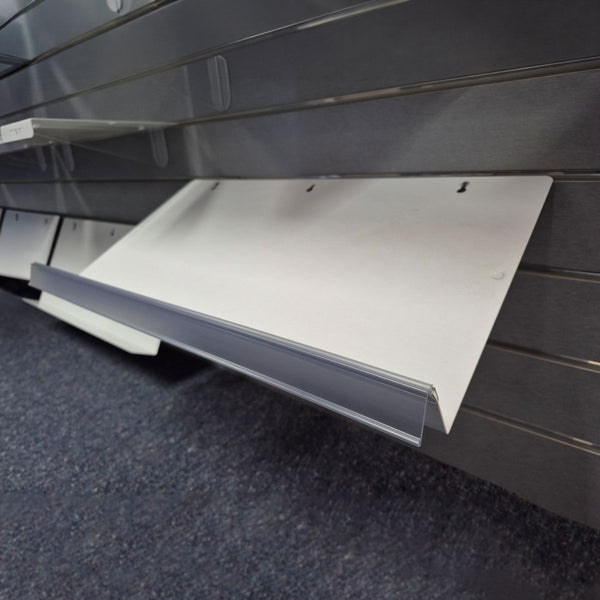 Metal sloping slatwall shelf with a clear branding clip-on strip