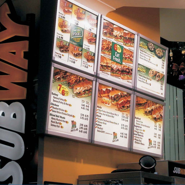 Subway restaurant menu board with various sandwich options and prices on Plankwall aluminium poster snap frame with a Split Rail wall mounting system, designed for fast and effortless graphic swaps in retail or hospitality environments