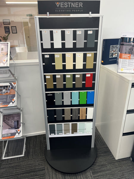 Black Plankwall rotating Slatwall display stand displaying paint samples  in retail store