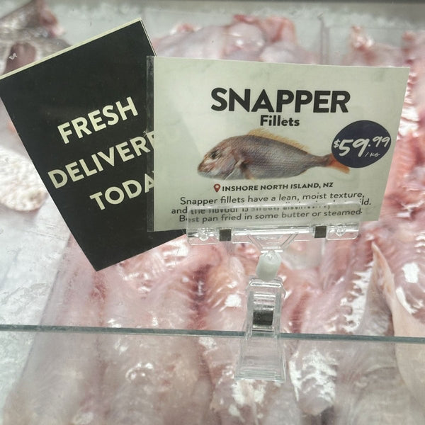 Retail messaging is visible with card clip  attached to a sales window at local fish shop.