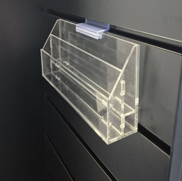 Clear plastic 2-slotted organizer attached to a black slatwall