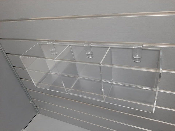 clear storage organiser on grey slatwall for small items held by slatwall clips