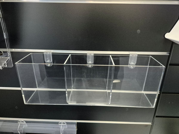 Clear plastic display case holder for small items on a black slatwall background