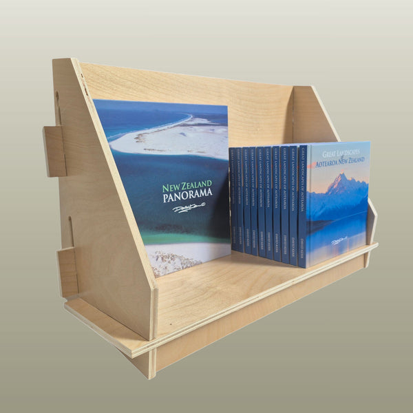 Custom made display wooden display rack with books titled 'New Zealand Panorama' on a white background