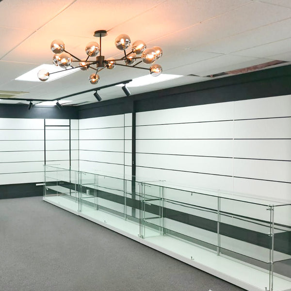 Custom slatwall display modern interior with glass display case and chandelier