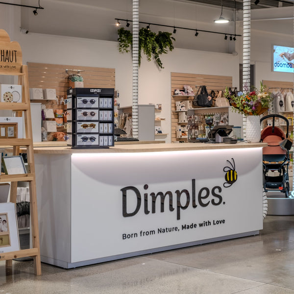 Store interior with a counter branded 'Dimples' featuring a bee logo.