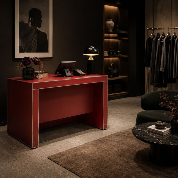 Modern interior design with a customised red desk with stickman aluminium edging  black lamp, and clothing rack.