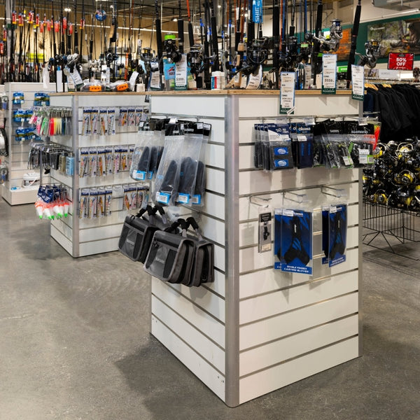 Display of fishing equipment in a store with shelves and products.