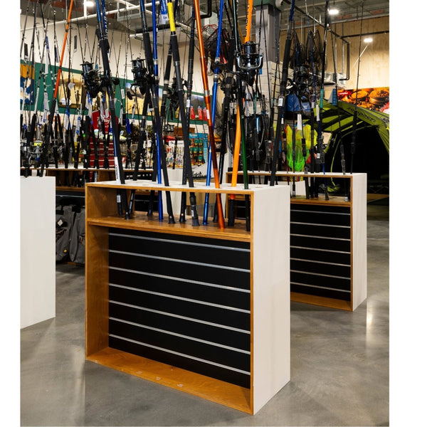 Display of fishing rods in a bespoke display case in a store setting