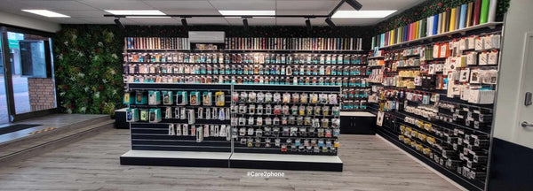 Custom store fit out for Care2Phone with gondolas and black slatwall wall panels