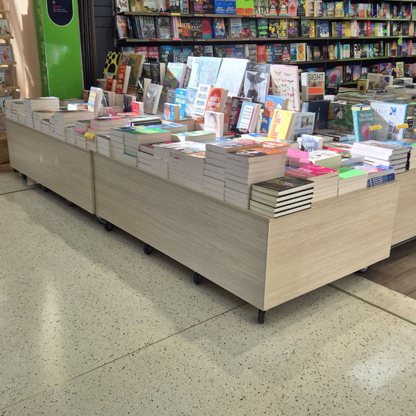 Book display case in a bookstore with books arranged on floor plinths