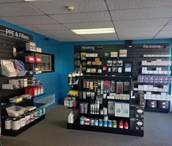 Extra strong gondola display with double plinth retail space holding paint supplies