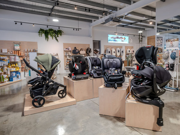 Display of baby strollers and car seats in a store setting