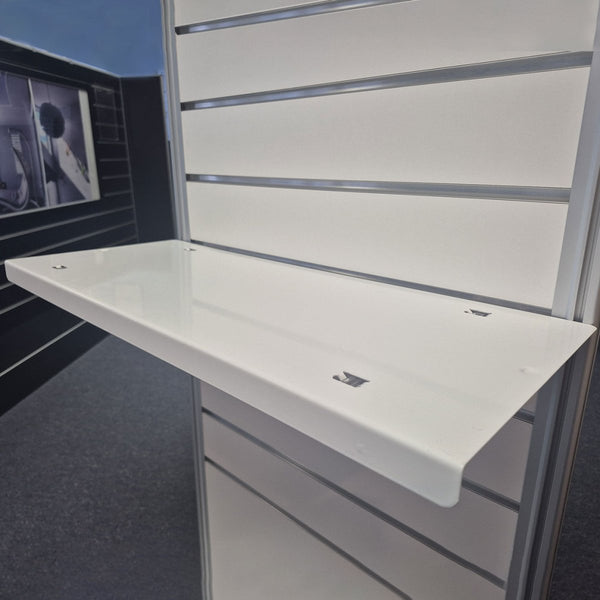 Flat metal slatwall shelf installed on retail display slatwall panel for clean, modern merchandising display.