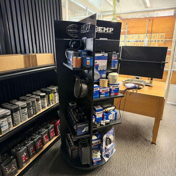 Rotating display rack with automotive parts in a store setting