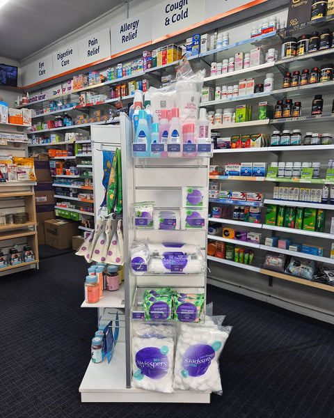 Plankwall's four-sided display tower shown here  at Unichem Howick pharmacy interior with shelves stocked with various products including a display of Swishpers.