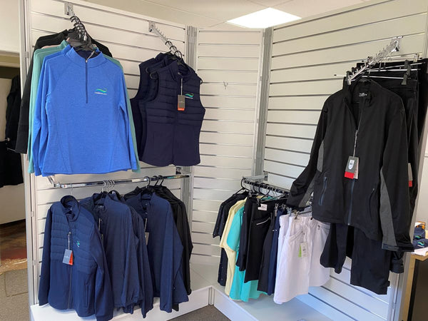 retail display slatwall uses Plankwall's waterfall display arm brackets to hang sports jackets for sale.