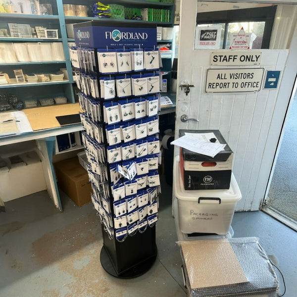 Black rotating display tower with Plankwall® panels for retail merchandising at Fiordland