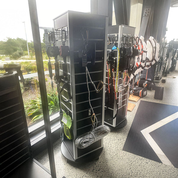 Black rotating Plankwall® retail panel display tower in retail shop