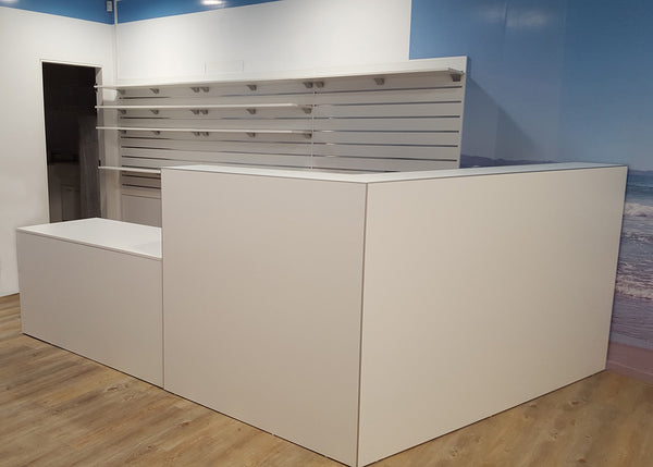 Modern white reception desk in a minimalistic office setting