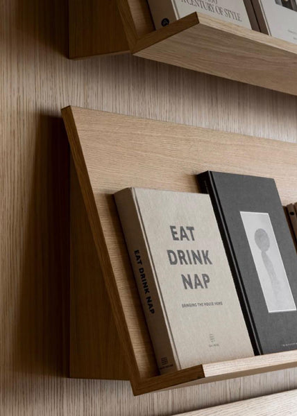 Wooden bookshelf with books against a wooden wall made in Plankwall Auckland factory