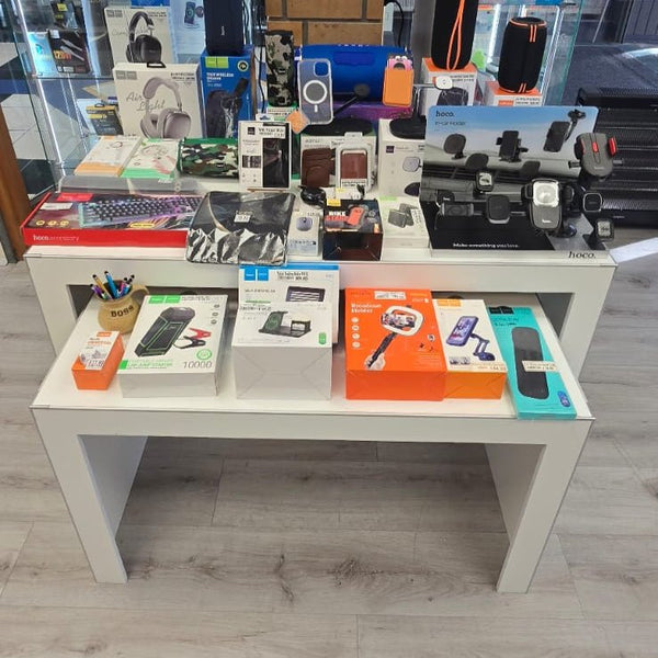 Plankwall nesting display tables x3 in electronics retail store displaying merchandise for sale