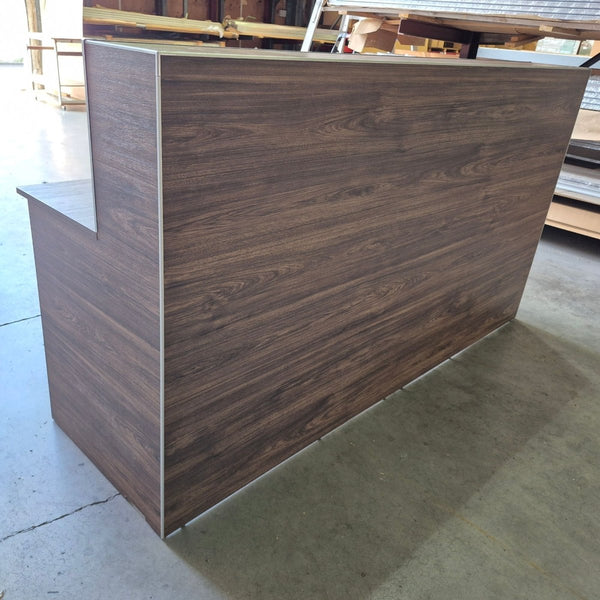 Plankwall wooden reception desk in a warehouse setting