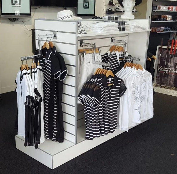 Display of black and white striped shirts on hangers hung on Plankwall's cranked arm slatwall bracket