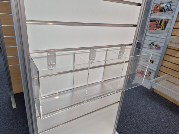 shown here are three clear acrylic display boxes mounted on slatwall with dividers for small retail items. 