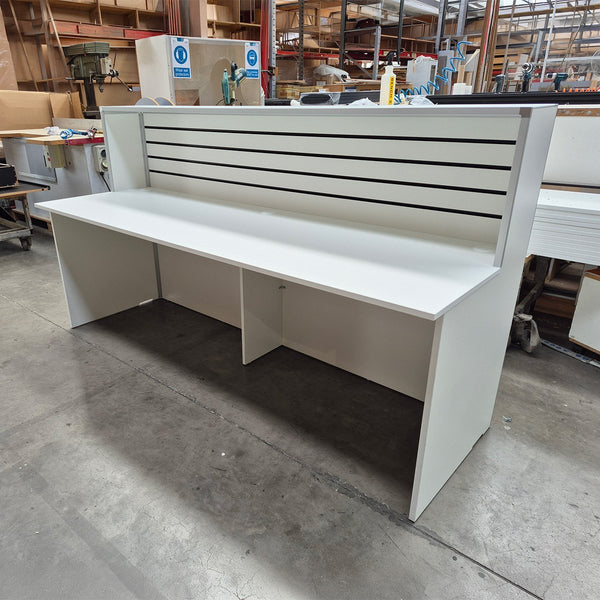 NZ made customised welcome counter featuring slatwall display front and MDF construction, built at Plankwall’s Auckland manufacturing facility
