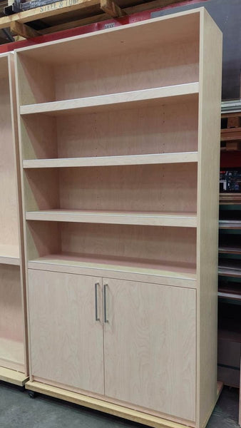 A cutout photo of a Plankwall Tall Display Cabinet in raw MDF with three  shelves and two cupboards