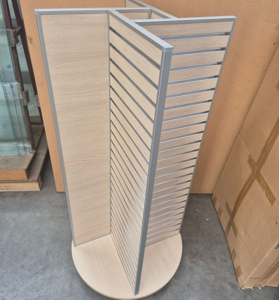 Plankwall four sided rotating retail display units  in perfect oak melamine slatwall with aluminium edging in a factory setting seen from above