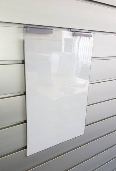 A clear leaflet display holder wall mounted on a slatwall panel using Plankwal supergrip clip