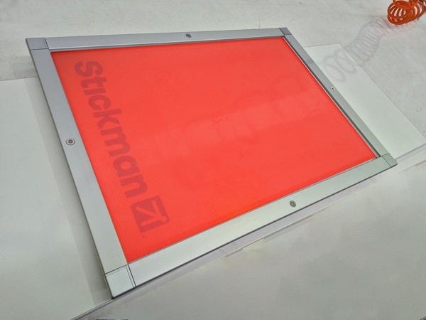 Photo of a Plankwall lockable aluminium snap frame for signs and posters shown on a workbench