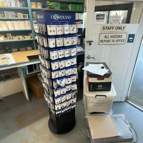 Black rotating display tower with Plankwall® panels for retail merchandising at Fiordland