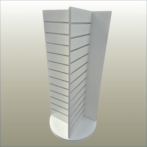 A white, free-standing four-sided display unit with slatwall panels on all sides, equipped with castor wheels for mobility.