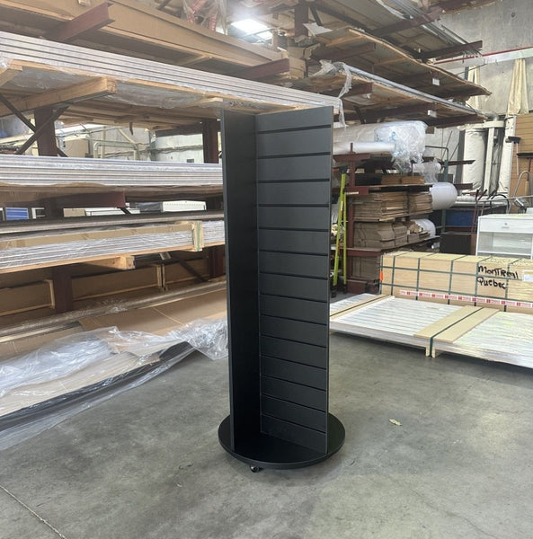 Another angle on the black on black four sided retail display stand powder coated in black with black inserts on a rotating plinth stand waiting for pickup at the factory in East Tamaki